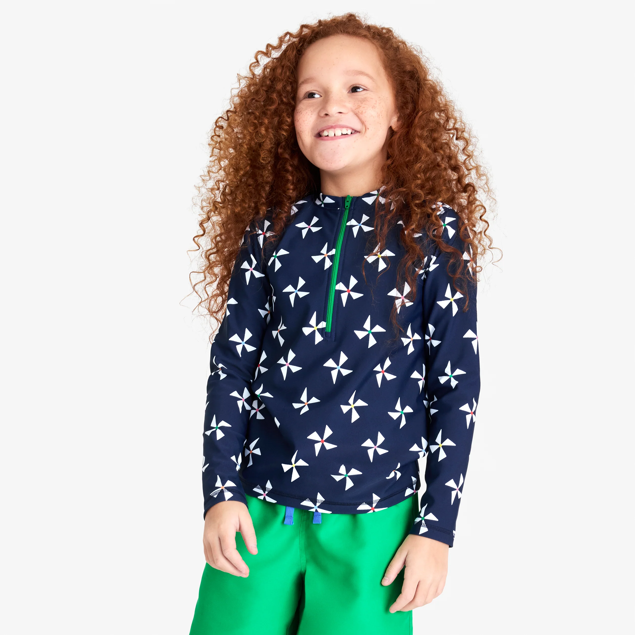 Kids long sleeve half-zip rash guard in rainbow pinwheels